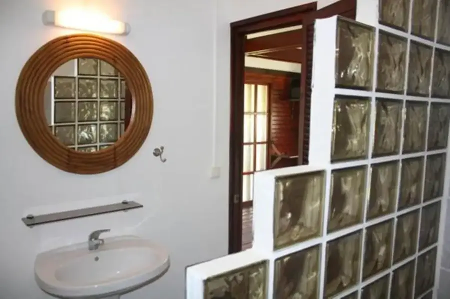 Salle de bain privative du bungalow studio avec vasque et miroir